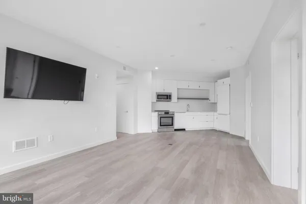 a view of a kitchen with a sink and cabinets