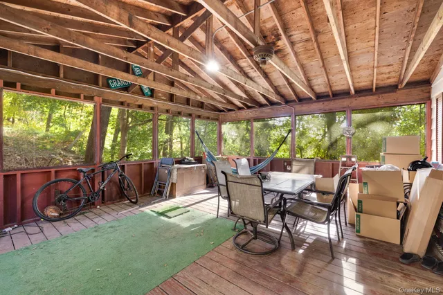 a view of a patio with table and chairs and wooden floor