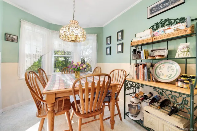 a view of a dining room and hall with furniture