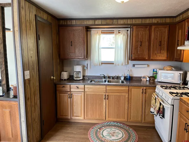 a kitchen with a refrigerator a stove a sink and a window