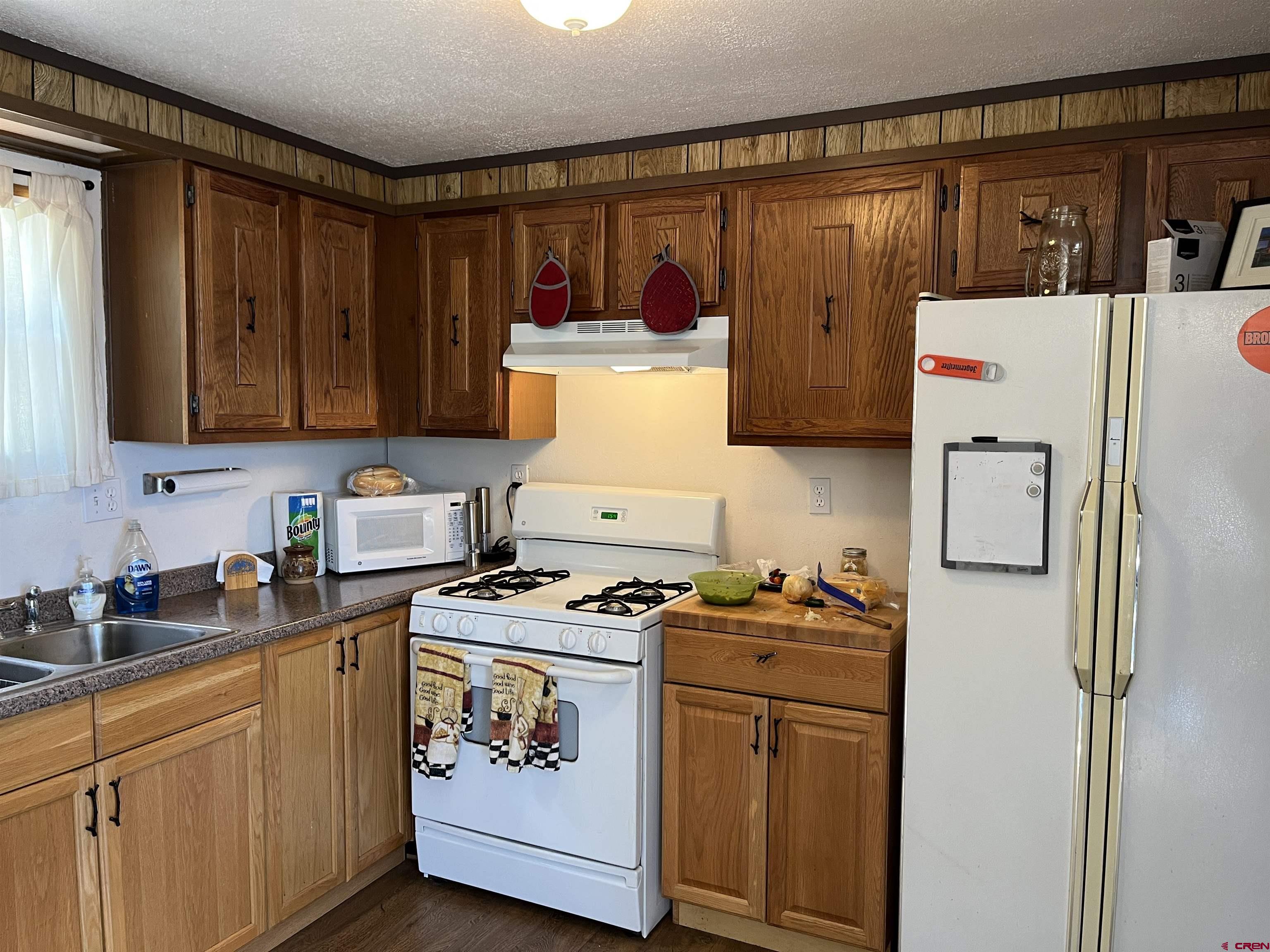320 Forest Service Road Pitkin, CO 81241 - Photo 5 of 16 a kitchen with stainless steel appliances a refrigerator a stove and wooden cabinets