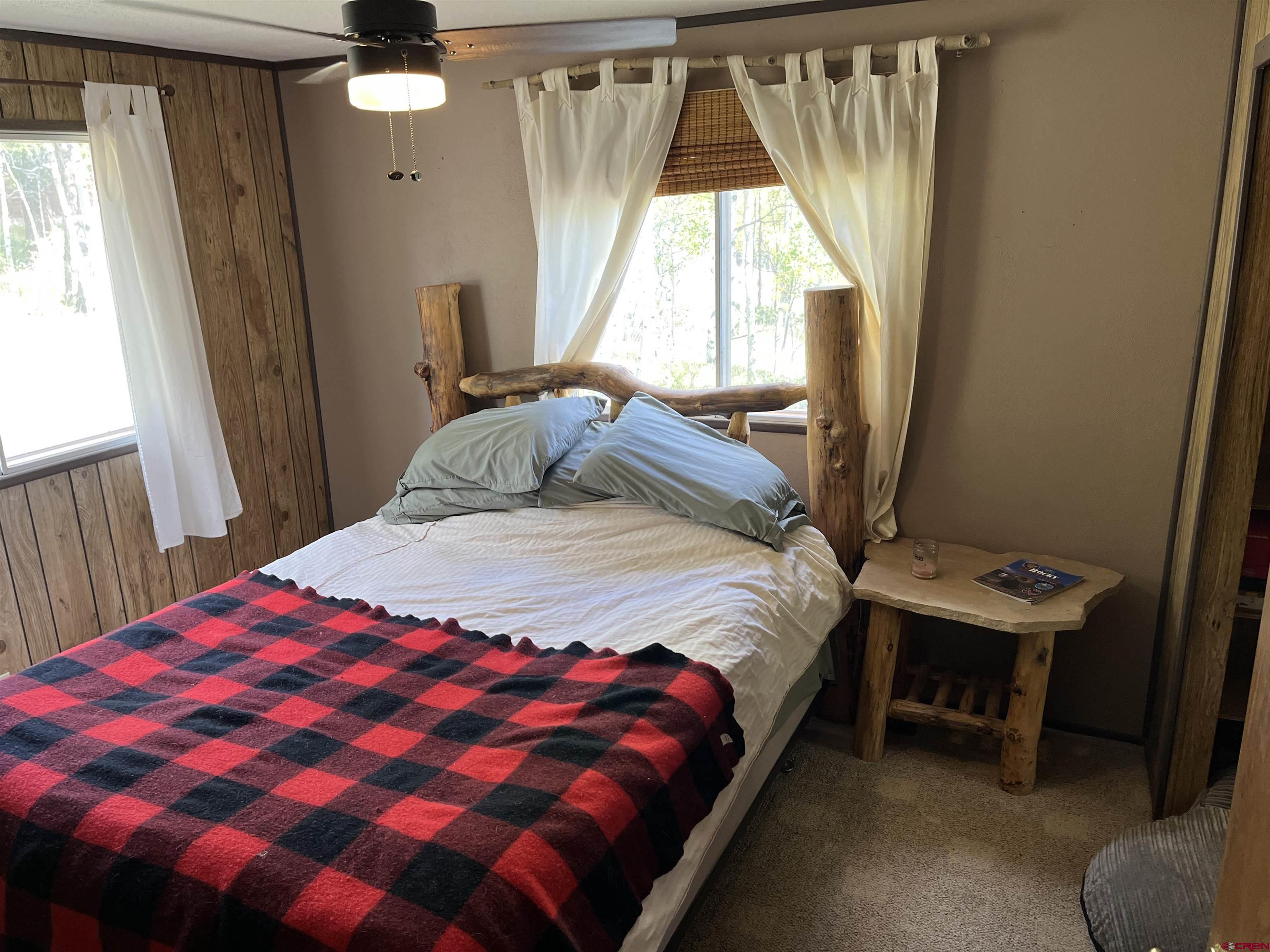 320 Forest Service Road Pitkin, CO 81241 - Photo 10 of 16 a bedroom with a bed and a window