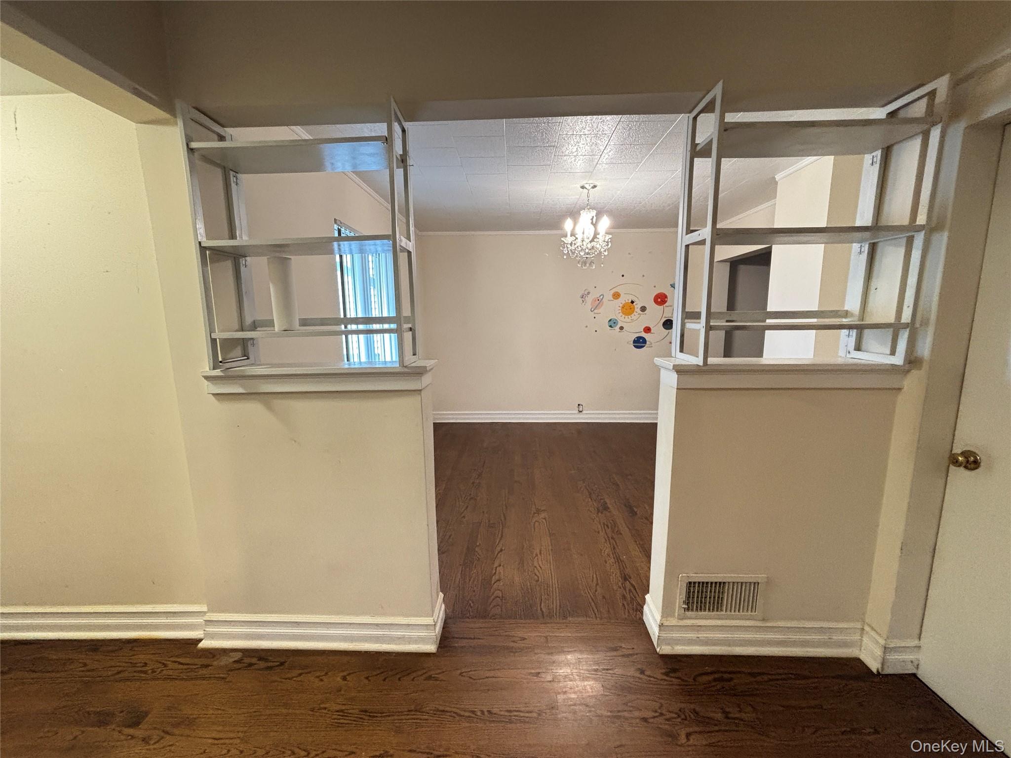 45 John Street New Rochelle, NY 10805 - Photo 7 of 14 a view of empty room with wooden floor and cabinet