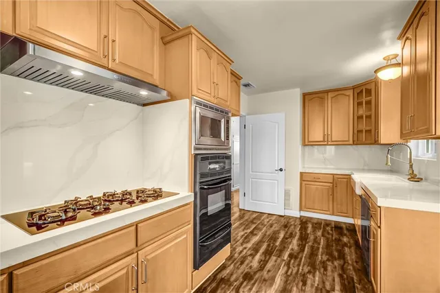 a kitchen with a stove and a refrigerator