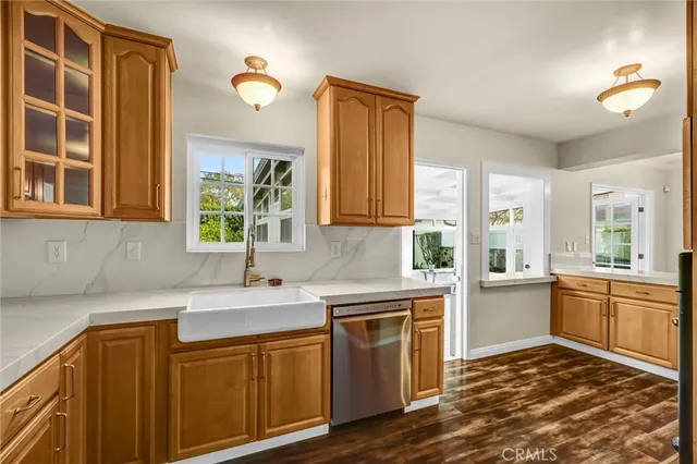 a kitchen with a sink stove and cabinets