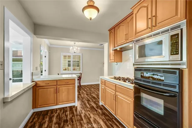a kitchen that has a stove and cabinets