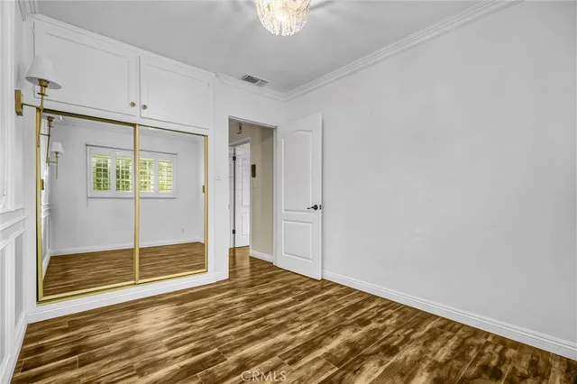 a view of a room with wooden floor and windows