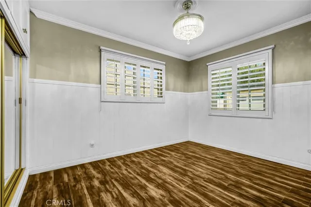 a view of a room with wooden floor and windows