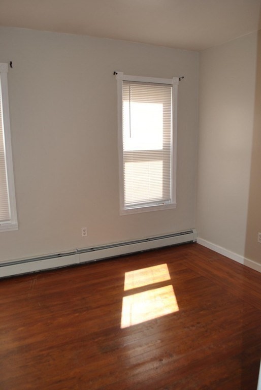40 I Street, Unit 3 Boston, MA 02127 - Photo 6 of 11 an empty room with wooden floor and windows