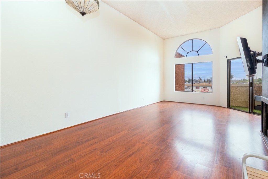 550 Orange Avenue, Unit 318 Long Beach, CA 90802 - Photo 1 of 25 an empty room with wooden floor cabinet and a window