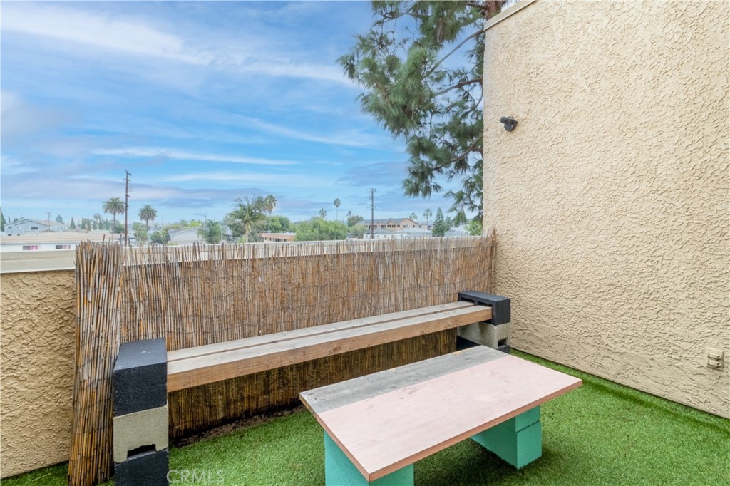 550 Orange Avenue, Unit 318 Long Beach, CA 90802 - Photo 12 of 25 a view of a small deck with a bench and yard in back