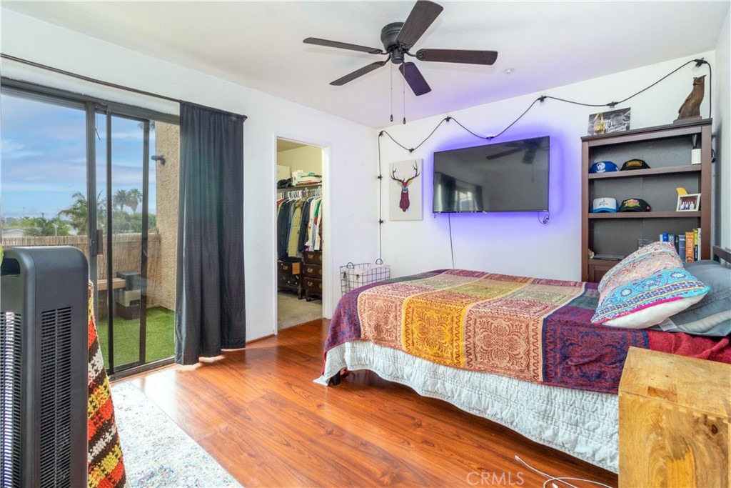 550 Orange Avenue, Unit 318 Long Beach, CA 90802 - Photo 2 of 25 a spacious bedroom with a bed and a flat screen tv