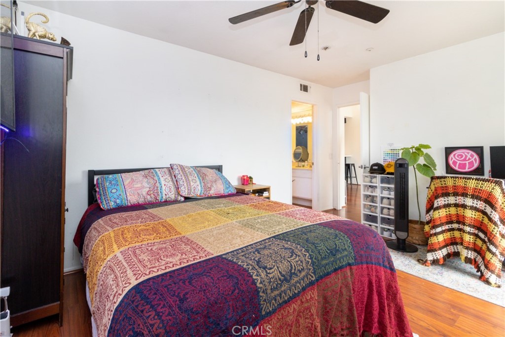 550 Orange Avenue, Unit 318 Long Beach, CA 90802 - Photo 4 of 25 a bedroom with a bed and dresser with mirror