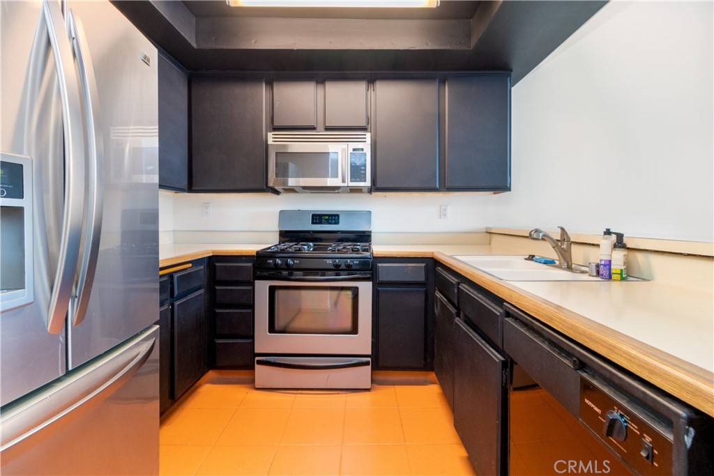 550 Orange Avenue, Unit 318 Long Beach, CA 90802 - Photo 8 of 25 a kitchen with a sink appliances and cabinets