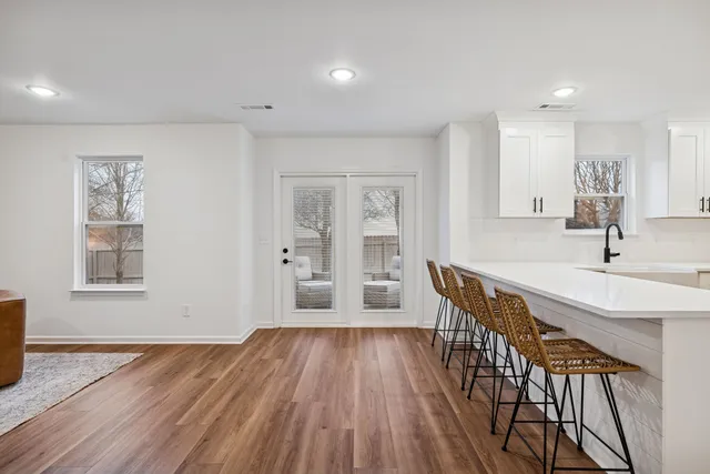 a view of a livingroom with wooden floor and staircase