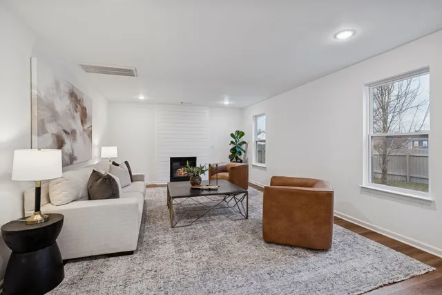 a living room with furniture and a fireplace