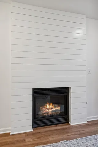 a living room with furniture wooden floor and a window