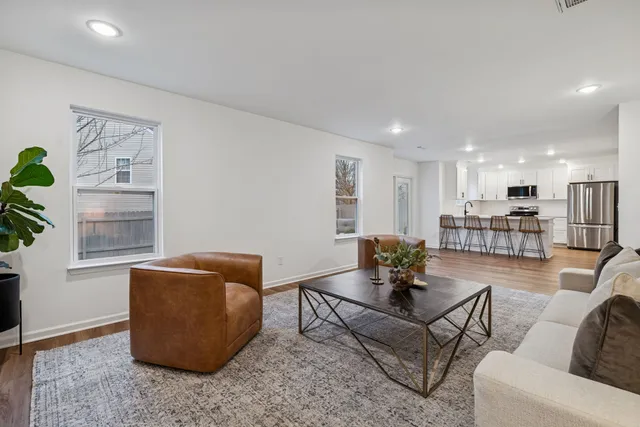 a living room with furniture and kitchen view