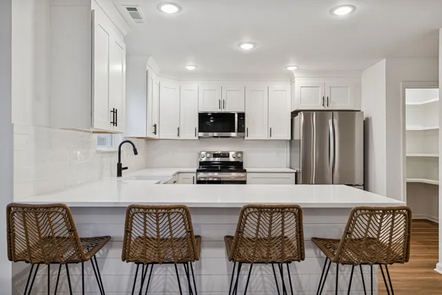 a kitchen with stainless steel appliances a refrigerator stove microwave and cabinets