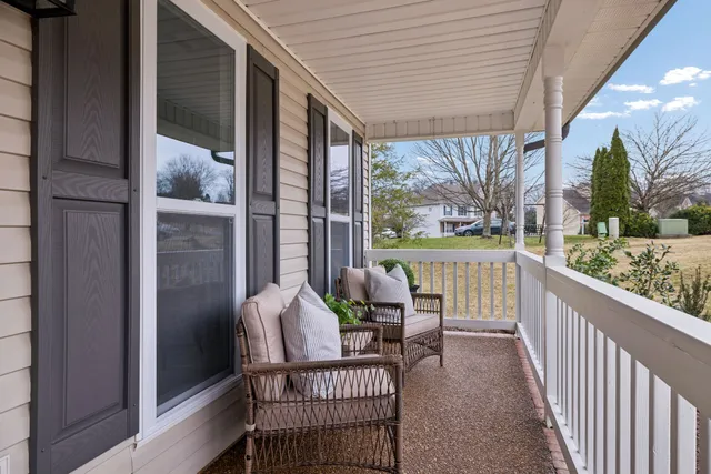 a view of a balcony with chair and wooden floor