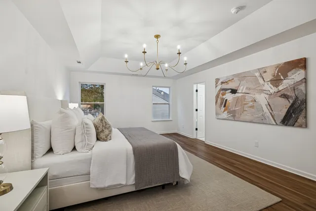 a bathroom with a double vanity sink a mirror a bathtub and shower