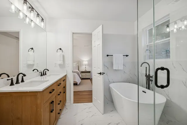 a bedroom with a large bed and a chandelier