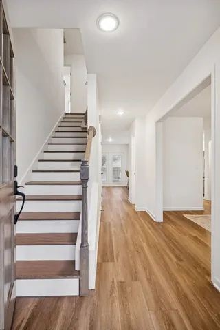 a view of entryway and hall with wooden floor