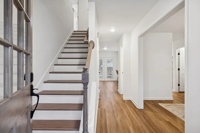 a view of entryway with wooden floor and stairs