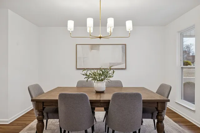 a dining room with furniture and window