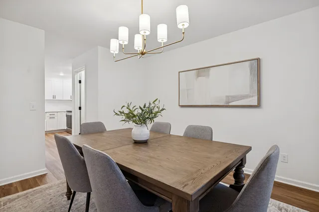 a dining room with wooden table and chairs