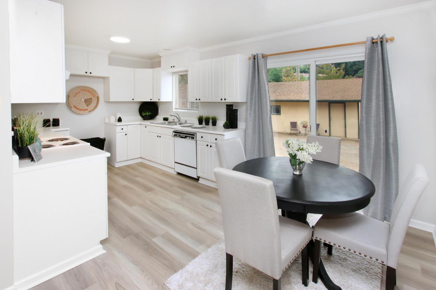 3005 Granite Creek Road Scotts Valley, CA 95066 - Photo 8 of 26 a kitchen with a table chairs a stove a microwave and cabinets