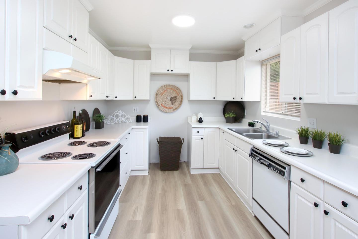 3005 Granite Creek Road Scotts Valley, CA 95066 - Photo 9 of 26 a kitchen with kitchen island white cabinets sink and white appliances
