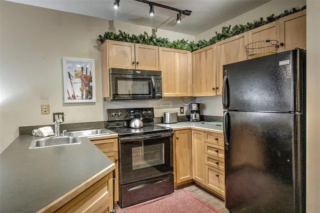 a kitchen with stainless steel appliances a refrigerator stove and sink