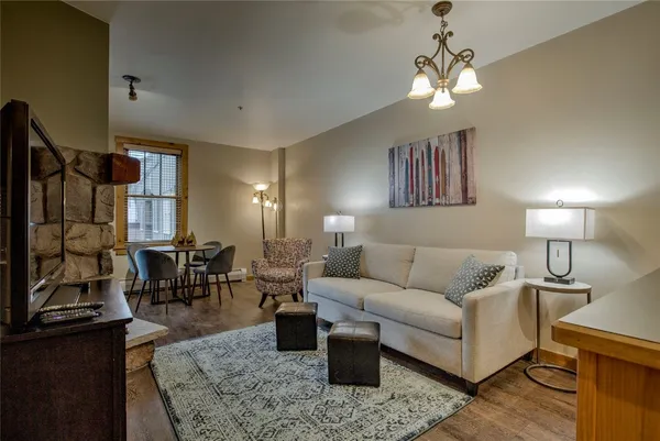 a living room with furniture and a chandelier