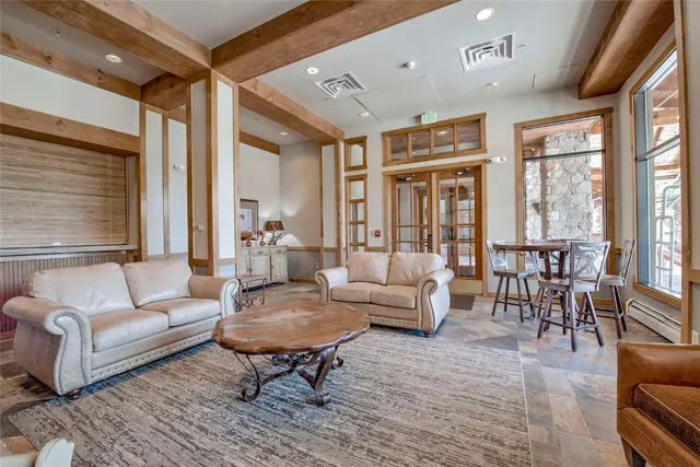 a living room with furniture a fireplace and a large window