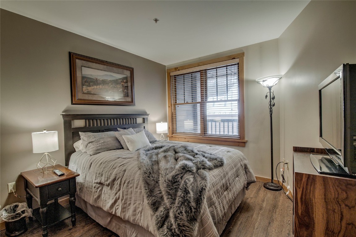 100 Dercum Square, Unit 8380 Keystone, CO 80435 - Photo 5 of 35 a bedroom with a bed and wooden floor