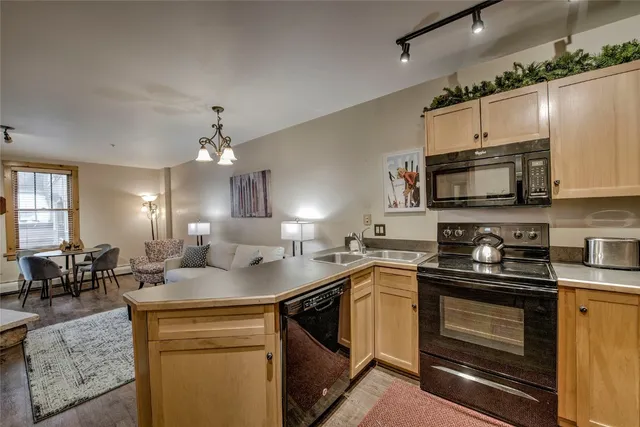 a kitchen with a sink stove and microwave