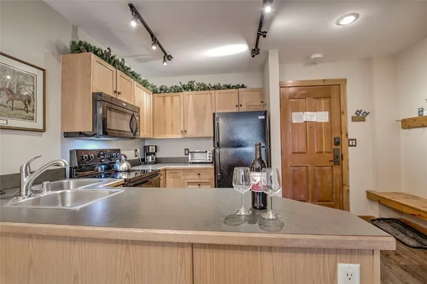 a kitchen with a sink a stove and cabinets