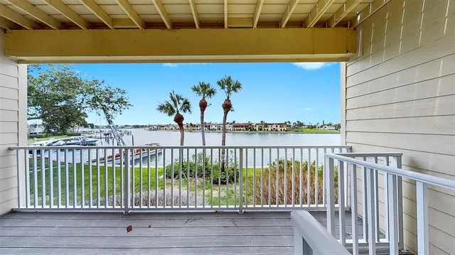 a dining room with wooden floor a chandelier a wooden table and chairs