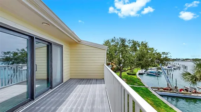 an aerial view of a houses with a yard and lake