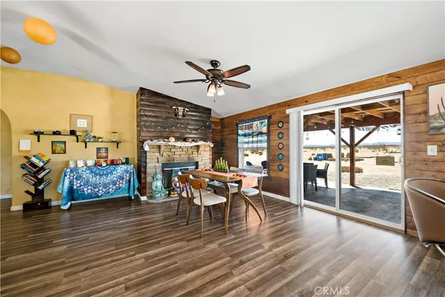 a dining room with furniture a chandelier and wooden floor
