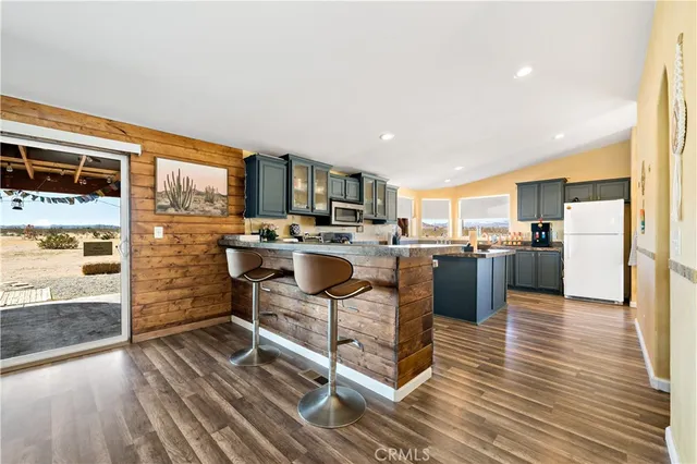 a kitchen with stainless steel appliances granite countertop a stove and cabinets