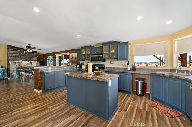 a kitchen with granite countertop a sink and cabinets