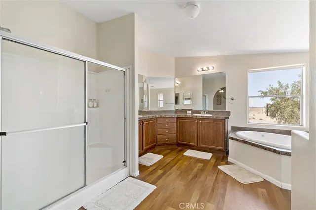 a bedroom with a bed and a flat tv screen on dresser