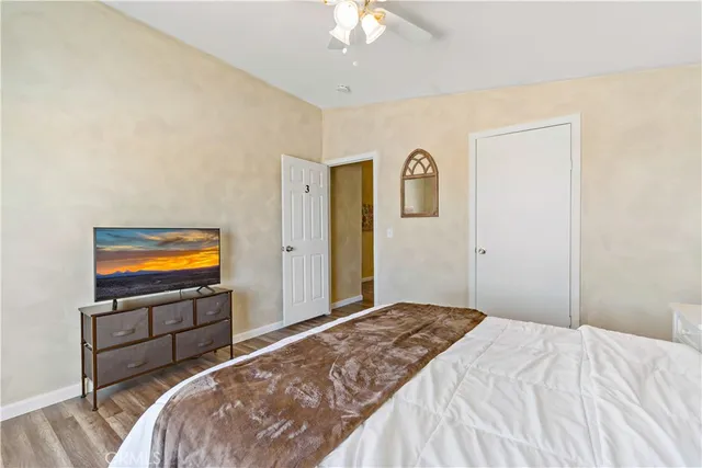 a view of a patio with table and chairs and couches with wooden floor and fence