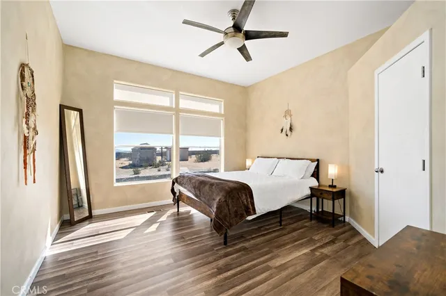 a view of a swimming pool with a patio and a yard