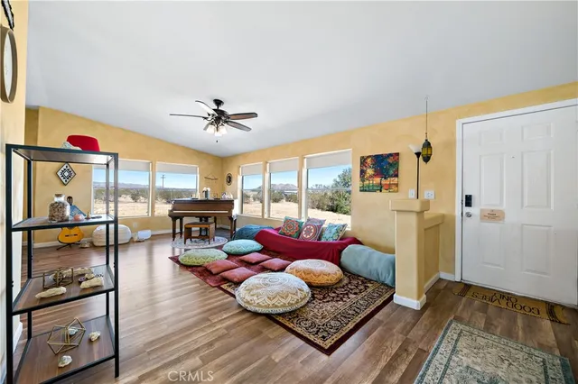 a living room with furniture and a floor to ceiling window