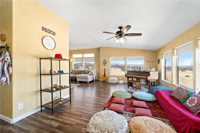 a living room with furniture a rug and a large window