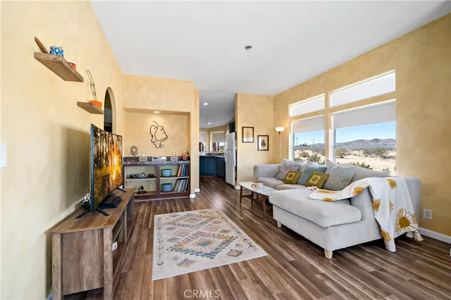 a living room with furniture window and wooden floor