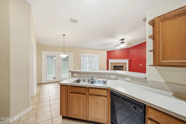 a spacious bathroom with a granite countertop sink a mirror and a shower